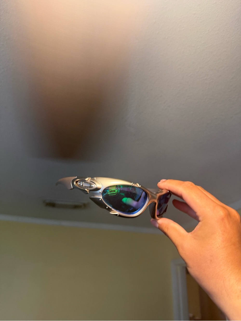 Sporty Metallic Silver Sunglasses with Blue-Green Mirrored Lenses Oakleys